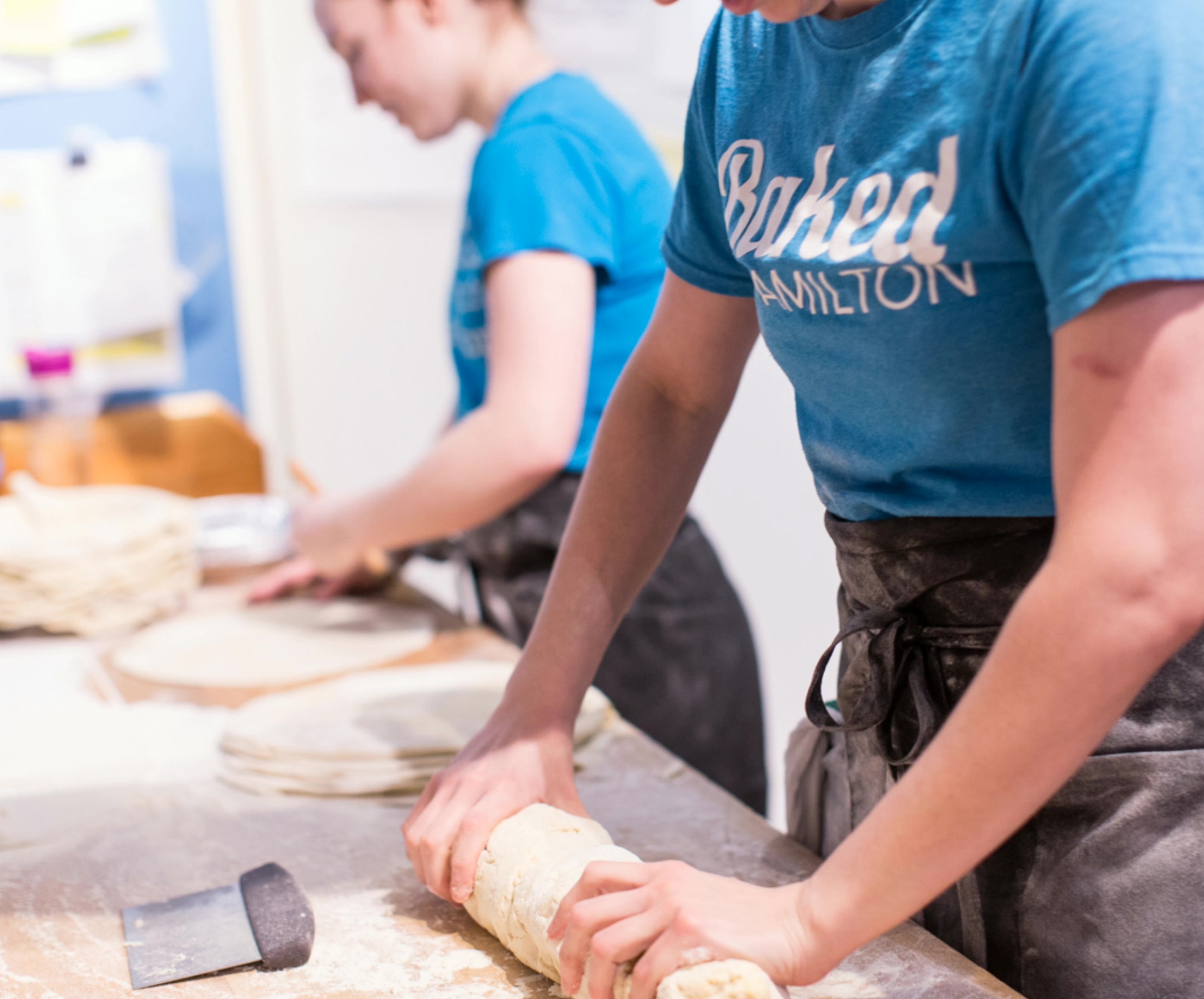 A bakery employee preparing dough